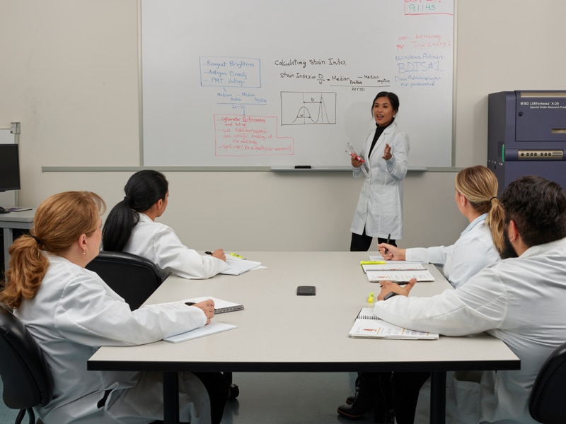 A scientist presenting information to a group of other scientists.