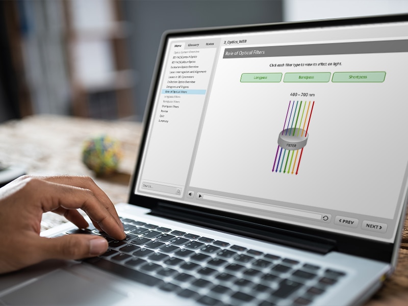 A person using their computer to review information about the role of optical filters.