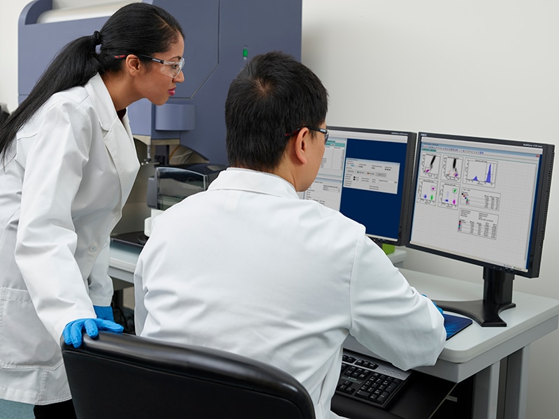 Two scientists reviewing their data in a lab.